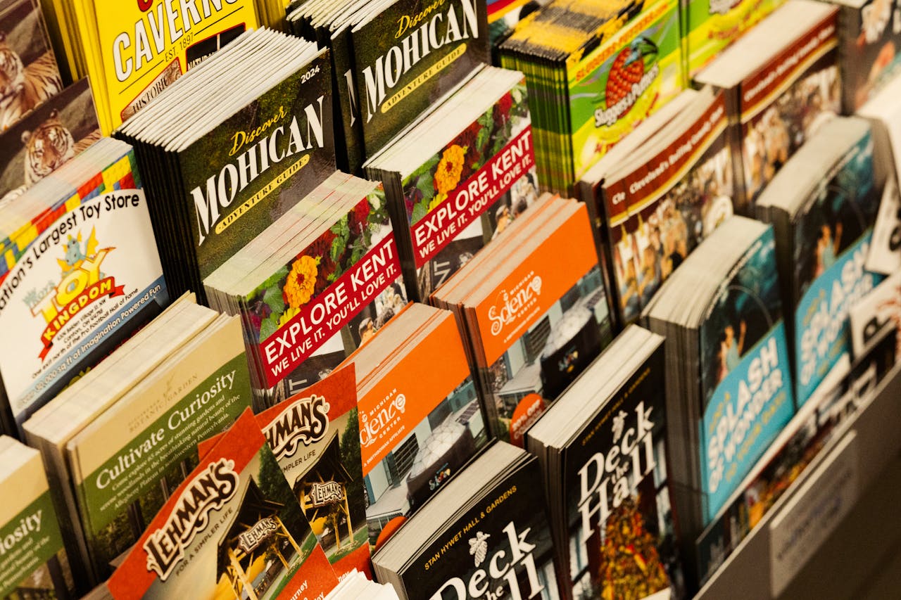 heros-img Colorful collection of travel brochures on display at a bookstore.